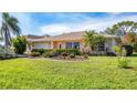 Single-story house with a well-maintained lawn and landscaping at 320 San Rafael Ave, North Port, FL 34287