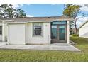 Front view of a single-story house with a grassy lawn at 6796 Gasparilla Pines Blvd # 62, Englewood, FL 34224