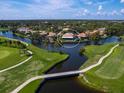 Home's aerial view showcases its waterfront location and canal access at 75 Cayman Isles Blvd, Englewood, FL 34223