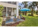 Relaxing patio with seating area, overlooking a lush green lawn at 815 Montrose Dr # 103, Venice, FL 34293