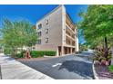Three-story building with attached garages and landscaping at 830 The Esplanade N # 203, Venice, FL 34285