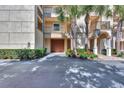 Private garage entrance with lush landscaping at 830 The Esplanade N # 203, Venice, FL 34285