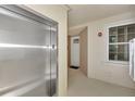 Interior hallway with elevator and unit access at 830 The Esplanade N # 203, Venice, FL 34285