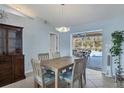 Dining room with light wood table and chairs, view of pool at 1030 Phorus Rd Rd, Venice, FL 34293