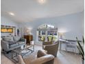 Light and airy living room with gray couches and large windows at 1030 Phorus Rd Rd, Venice, FL 34293