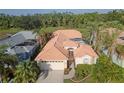 Bird's eye view of a single story house with a tile roof and nicely landscaped yard at 229 Venice Palms Blvd, Venice, FL 34292