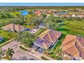 Aerial view of a house in a community near a golf course at 4665 Whispering Oaks Dr, North Port, FL 34287