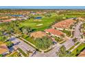 Aerial view of the house and surrounding golf course community at 4665 Whispering Oaks Dr, North Port, FL 34287