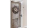 Inviting condo entry with a lovely lavender wreath at 612 Bird Bay S Dr # 114, Venice, FL 34285
