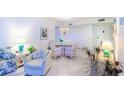 Living room features comfy seating and a view to dining area at 612 Bird Bay S Dr # 114, Venice, FL 34285
