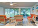 Bright sunroom with wicker furniture and view of backyard at 618 Circlewood Dr # S2-15, Venice, FL 34293