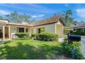 Condo with shingled roof and lush landscaping at 6906 Woodwind Dr # 12, Sarasota, FL 34231