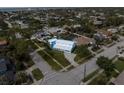 Aerial view of property highlighting blue trim exterior, landscaping, and location close to beach at 842 Nokomis S Ave, Venice, FL 34285