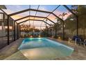 Screened pool area with pavers and seating, perfect for relaxing evenings and enjoying the sunset at 842 Nokomis S Ave, Venice, FL 34285