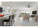 Open concept living room and kitchen with neutral colors at 13825 Karina St, Venice, FL 34293