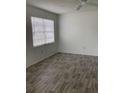 Bright living room featuring gray flooring and a large window at 20044 Sancraft Ave, Port Charlotte, FL 33954