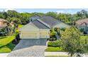 Aerial view of a yellow house with gray roof, two-car garage, and lush landscaping at 21248 St Petersburg Dr, Venice, FL 34293