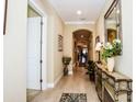 Long entryway with tile floors and decorative accents at 23739 Waverly Cir, Venice, FL 34293