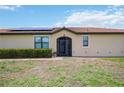 House exterior featuring solar panels and a screened entryway at 24036 Spartina Dr, Venice, FL 34293