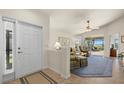 Bright and airy entryway with a view into a living room with a tiled floor and access to a lanai at 3897 Fairway Dr, North Port, FL 34287