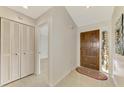 Bright entryway with tile flooring, a wooden door, and a closet at 4765 Oak Forest W Dr # 47, Sarasota, FL 34231