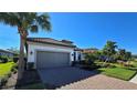 One-story house with gray garage door and well-manicured lawn at 5307 Cicerone St, Sarasota, FL 34238