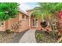 Brick walkway leads to a double-door entry with decorative columns and landscaping at 6255 Aventura Dr, Sarasota, FL 34241