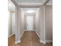 Inviting front hallway featuring wood floors, crisp white trim, and a bright, neutral palette at 660 Ravello Blvd, Nokomis, FL 34275