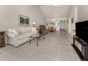 Open living space with tile floors, neutral walls and furniture at 694 Bird Bay W Dr # 137, Venice, FL 34285