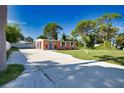 Well-maintained single story home with a driveway and a lush lawn at 1605 Phillip Pl, Englewood, FL 34223