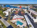 Aerial view showing condo building, pool, parking, and marina at 250 Santa Maria St # 219, Venice, FL 34285