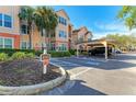 Condo building with covered parking and address marker at 4142 Central Sarasota Pkwy # 1415, Sarasota, FL 34238