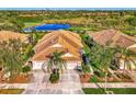 Community overview showcasing homes near a pond and golf course at 4245 Whispering Oaks Dr, North Port, FL 34287