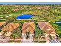 Community overview showcasing homes near a pond and golf course at 4245 Whispering Oaks Dr, North Port, FL 34287
