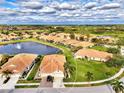 Aerial view showcasing a single-Gathering home in a tranquil community by the lake at 4980 Whispering Oaks Dr, North Port, FL 34287