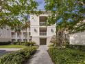 Building entrance with walkway and lush landscaping at 500 San Lino Cir # 521, Venice, FL 34292