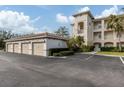 Four-car garage with beige doors and exterior lighting at 500 San Lino Cir # 521, Venice, FL 34292