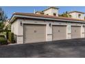 Three-car garage with beige doors and exterior lighting at 500 San Lino Cir # 521, Venice, FL 34292