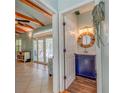 Small powder room with navy blue vanity and a round mirror at 716 Groveland Ave, Venice, FL 34285