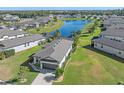 House and backyard aerial view showing pool and lake view at 8574 Starlight Loop, Parrish, FL 34219