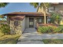 Condo entrance with stone and wood accents at 927 Capri Isles Blvd # 5, Venice, FL 34292