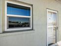 Condo building exterior with window and door detail at 950 Tarpon Center Dr # 202, Venice, FL 34285