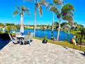 Enjoy serene lake views from this spacious patio with seating for four at 966 Jolanda Cir, Venice, FL 34285