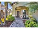 Inviting front entrance with covered porch and paver walkway at 11897 Hunters Creek Rd, Venice, FL 34293