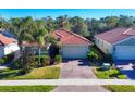 Single-Gathering home with a driveway and a lush green lawn at 19348 Yellowtail Ct, Venice, FL 34292