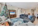 Spacious living room with a comfortable sectional sofa and a large TV at 19348 Yellowtail Ct, Venice, FL 34292