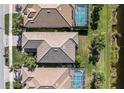 Aerial view showing multiple homes with pools and lush landscaping at 19397 Rizzuto St, Venice, FL 34293