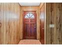 Simple entryway with wood-paneled walls and a classic door at 2281 Mars Rd, Venice, FL 34293