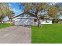 House exterior showcasing a large tree and grassy lawn at 2281 Mars Rd, Venice, FL 34293