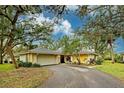 Charming yellow one-story home with attached garage and landscaped yard at 263 Southampton Dr # 301, Venice, FL 34293